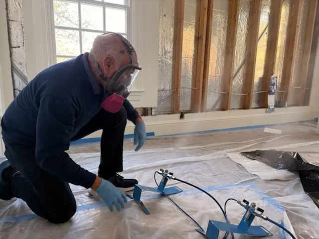 A restoration technician setting drying equipment in an Torrance home stripped to the studs